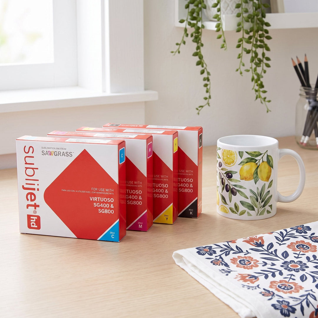 SubliJet-HD ink for Sawgrass Virtuoso SG400: red SubliJet HD cartridge boxes, a lemon print mug and a folk floral tea towel on a desk