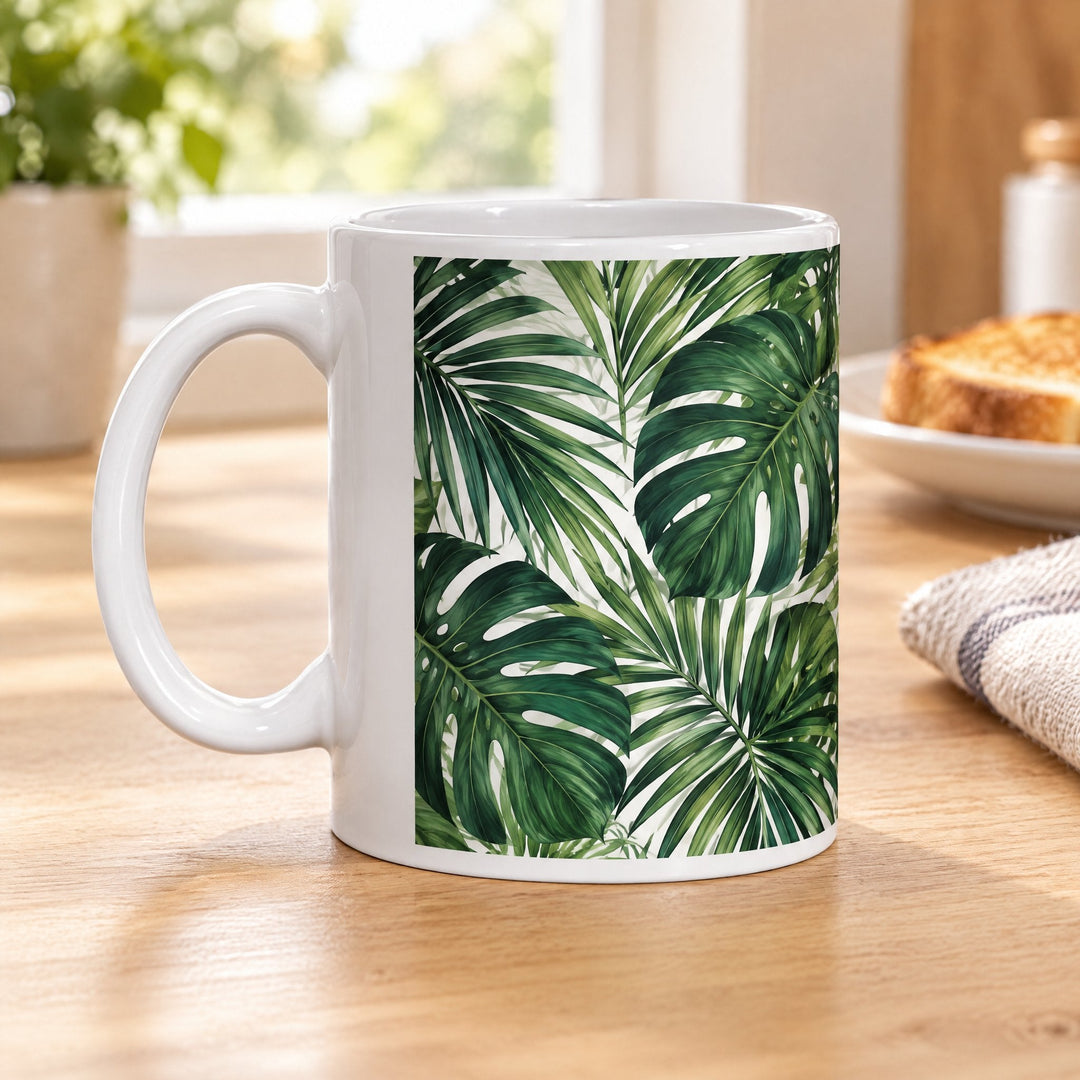 10oz Durham super glaze sublimation mug printed with palm and monstera leaves, on a wooden kitchen table
