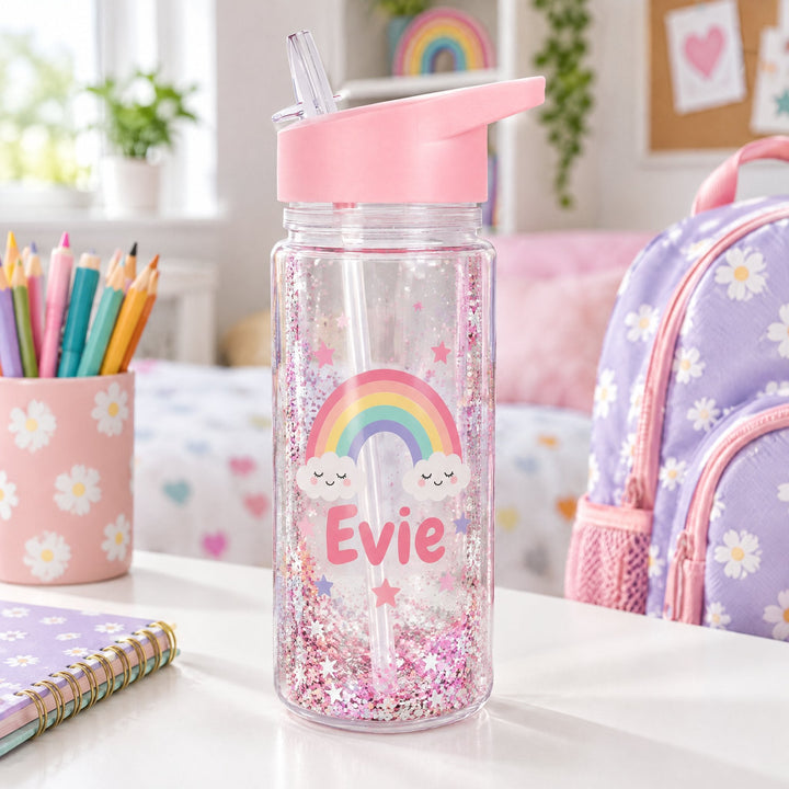 10oz snowglobe bottle printed with a pastel rainbow, stars and the name Evie, on a child&