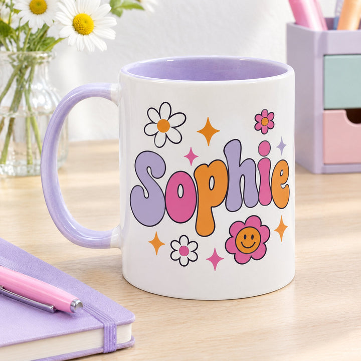 11oz lilac inner &amp; handle sublimation mug printed with retro daisies and the name Sophie, on a wooden desk by a notebook