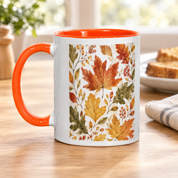 11oz orange inner &amp; handle sublimation mug printed with autumn leaves, on a wooden kitchen table