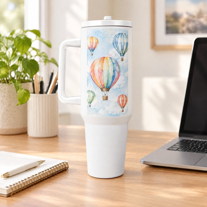 40oz tumbler printed with watercolour hot-air balloons, on a wooden desk