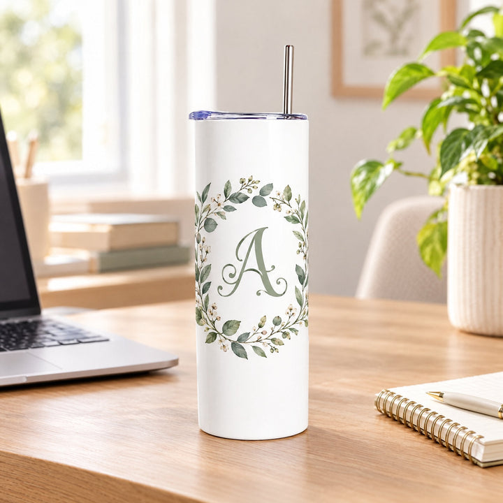 600ml stainless steel tumbler printed with an ornate decorative initial design, on a wooden desk