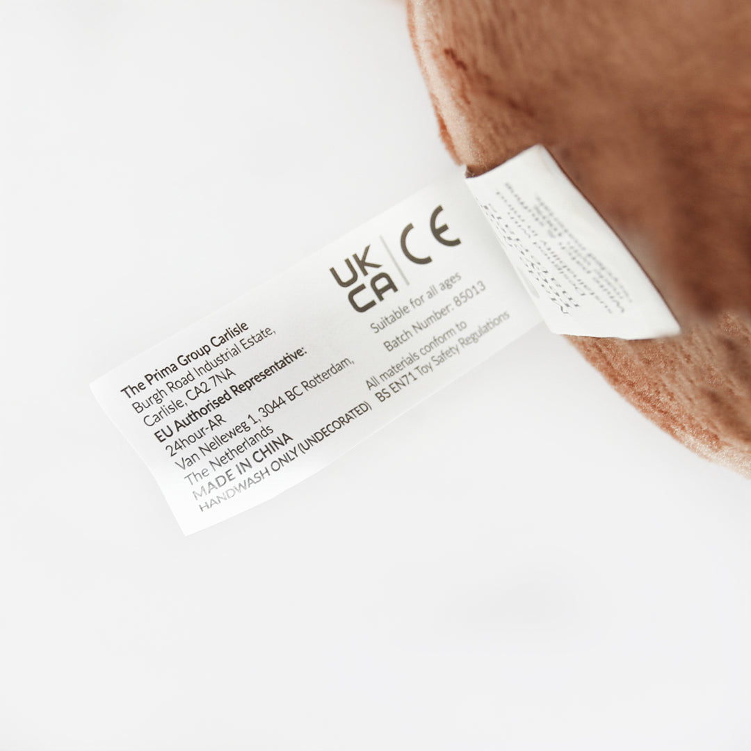 Christmas Pudding plush toy safety label showing UKCA and CE marks and BS EN71 compliance