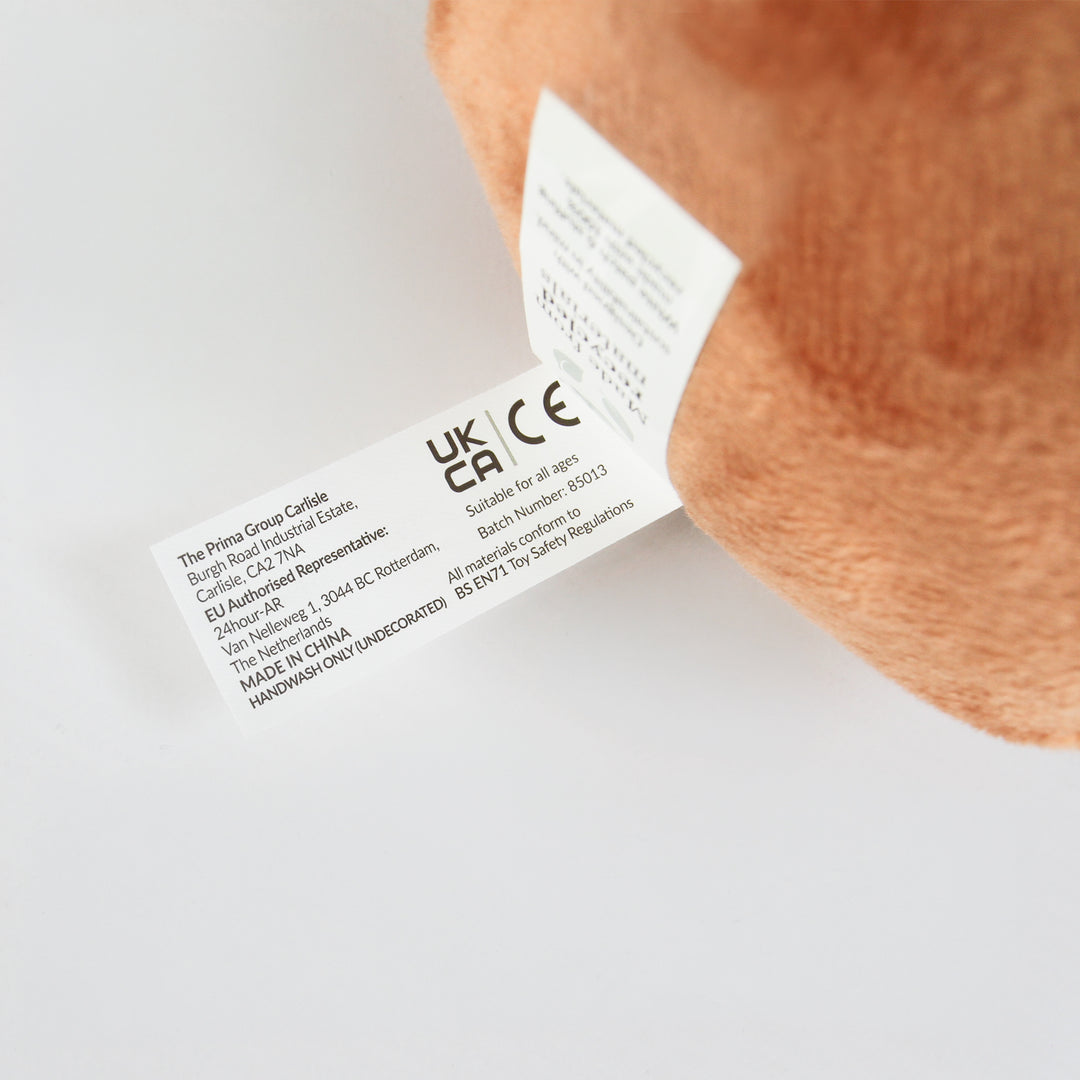 Christmas Tree plush toy safety label showing UKCA and CE marks and BS EN71 compliance