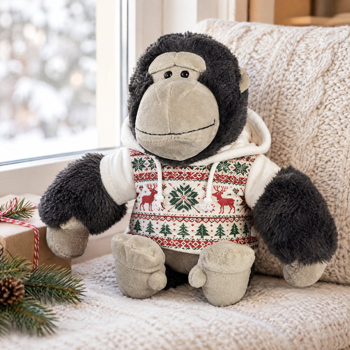 Hoodies for teddy bears printed with a Nordic snowflake-and-reindeer pattern, on a window seat