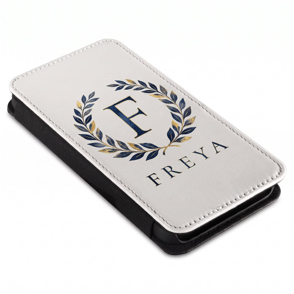 iPhone 14 phone cover printed with a navy and gold laurel wreath, a letter F and the name Freya