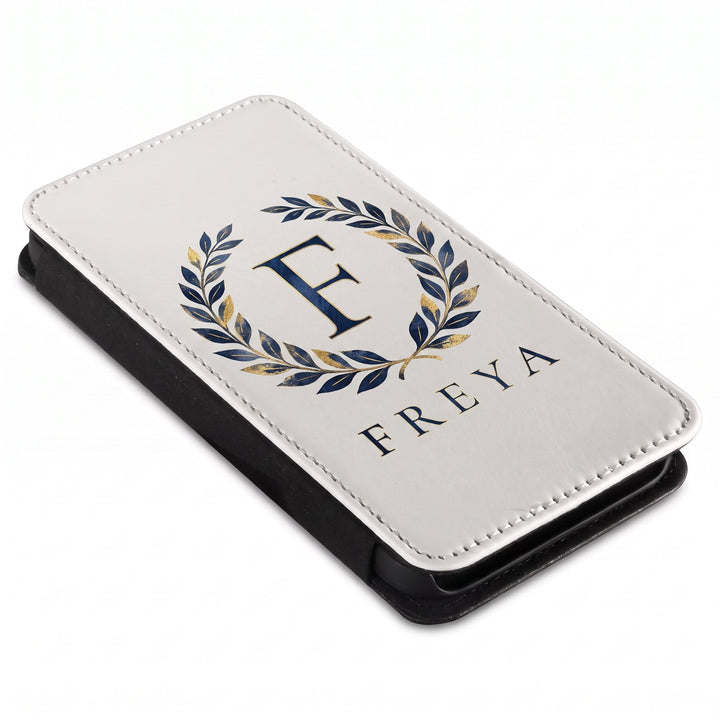 iPhone 14 phone cover printed with a navy and gold laurel wreath, a letter F and the name Freya