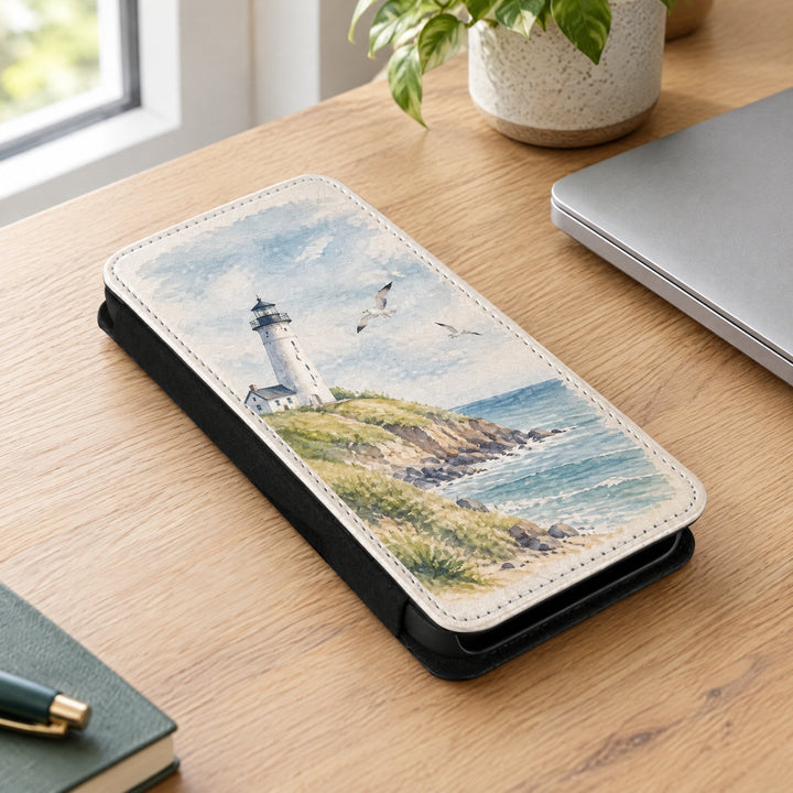 iPhone 14 Pro Max phone case printed with a white lighthouse design, lying on a desk