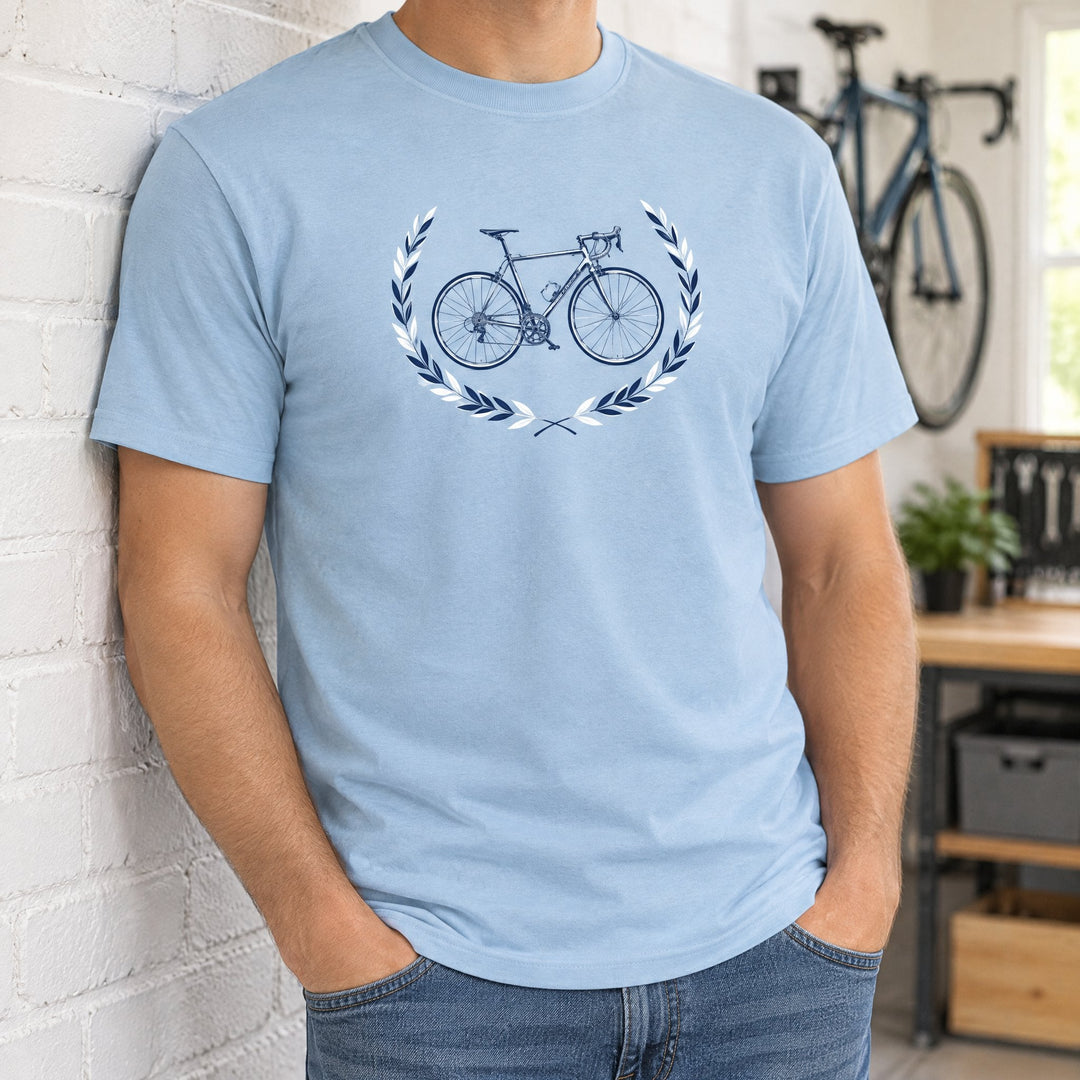 Mens Gildan light blue ultra cotton T-shirt, large, printed with a road bicycle design, worn by a brick wall
