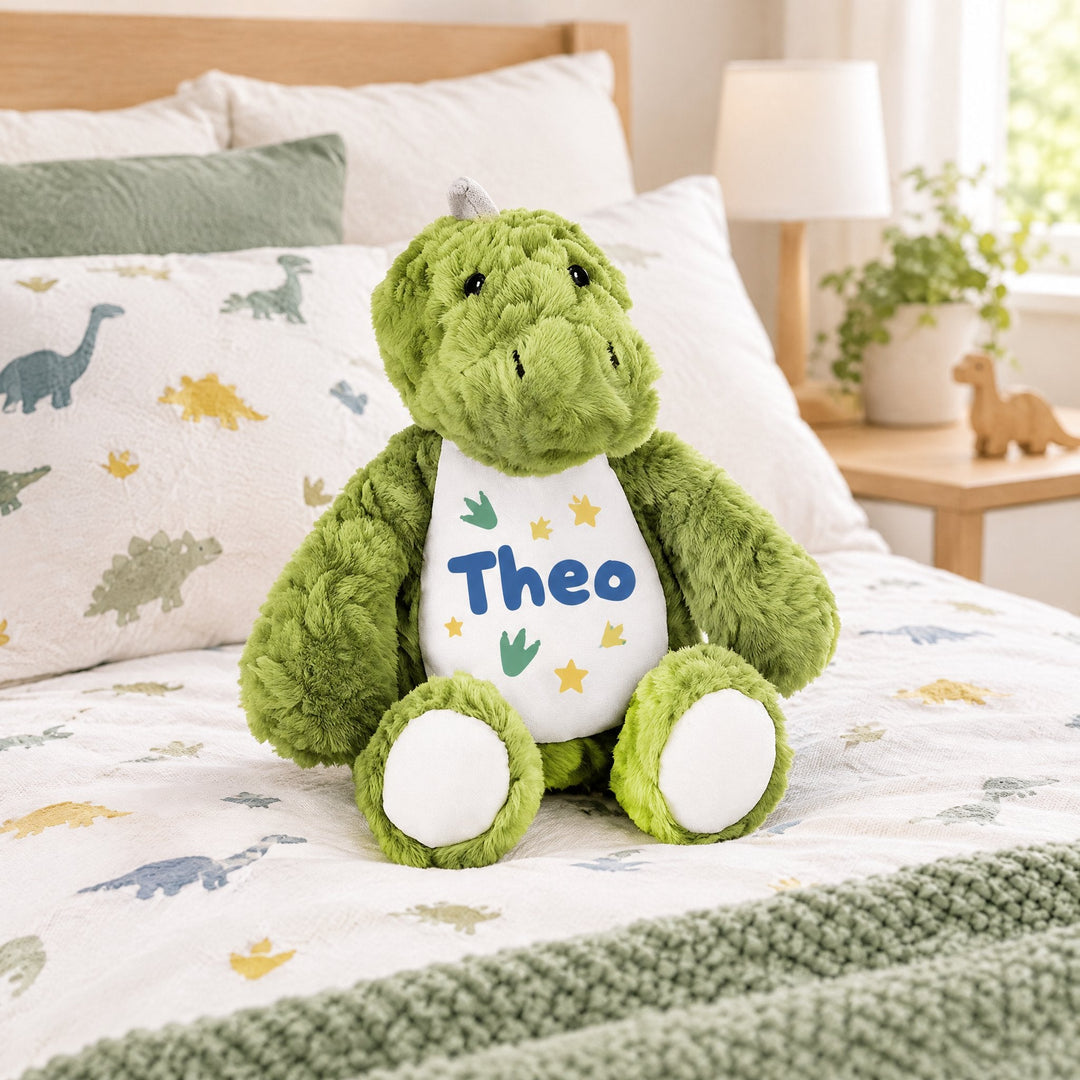 Sublimation dinosaur plush toy printed with dinosaur footprints and stars and the name Theo, on a child&
