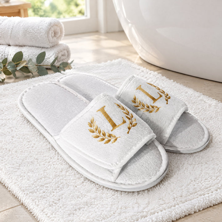 Sublimation hotel slippers printed with a monogram L, on a bath mat