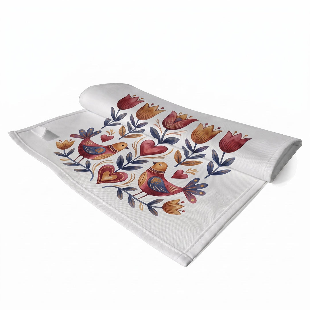 Sublimation tea towels, small, printed with folk-art birds, hearts and tulips in red, mustard and navy, shown folded