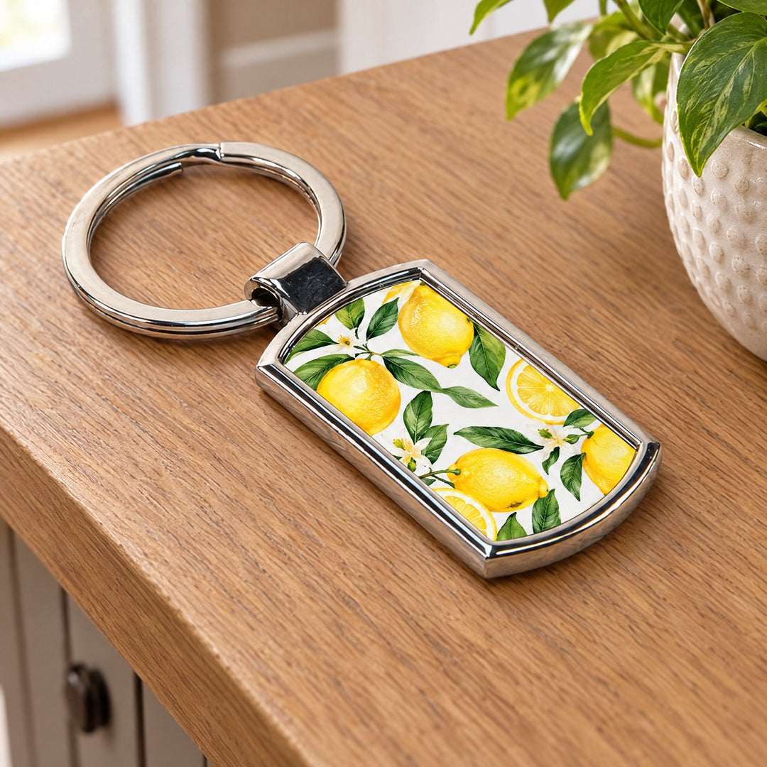 Tag shaped key ring printed with lemons and green leaves, on a hallway console table