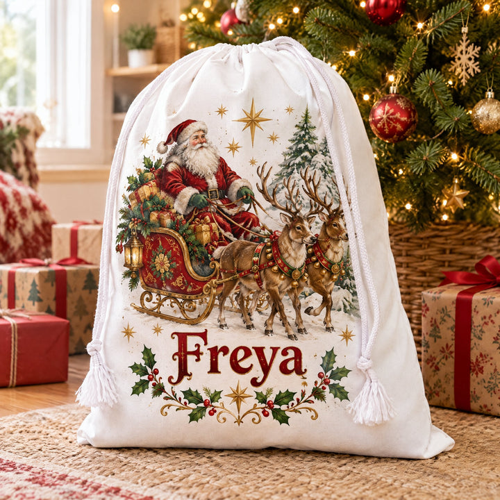 White cotton drawstring sack 40 x 50cm printed with Father Christmas and stars, under a decorated Christmas tree